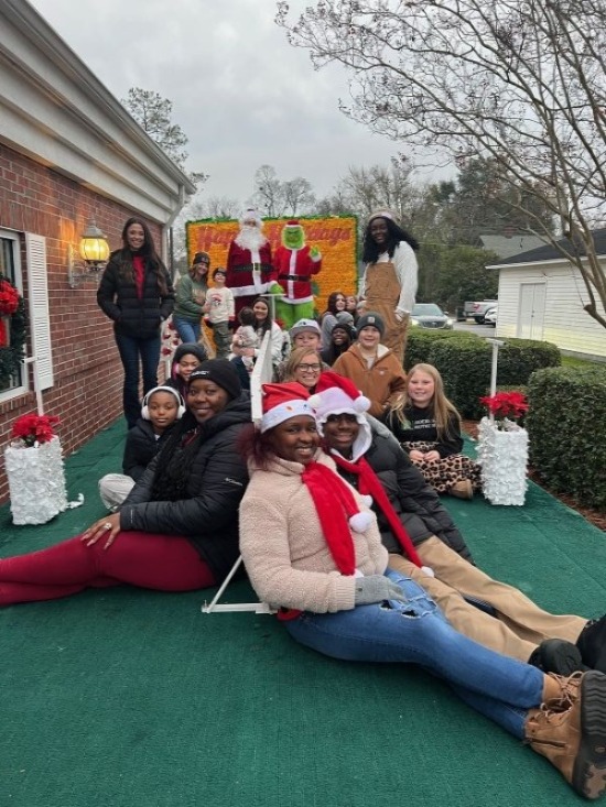 Santa and the Grinch with ABB employees on Christmas parade float